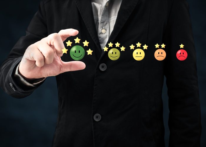 person hand choose happy smile face icon and five star symbol to increase rating of product and service concept, Customer service experience and business satisfaction survey.